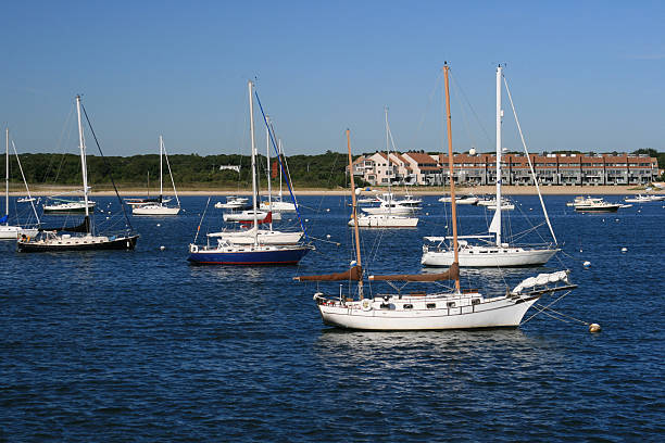 Sailboats moored at Hyannis Harbor, Cape Cod, Massachisetts. Blue sky. stock photo