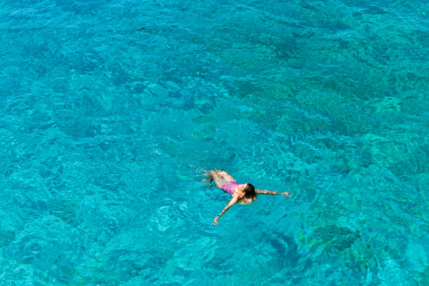 istock Woman floating in immaculate sea. 1166563015