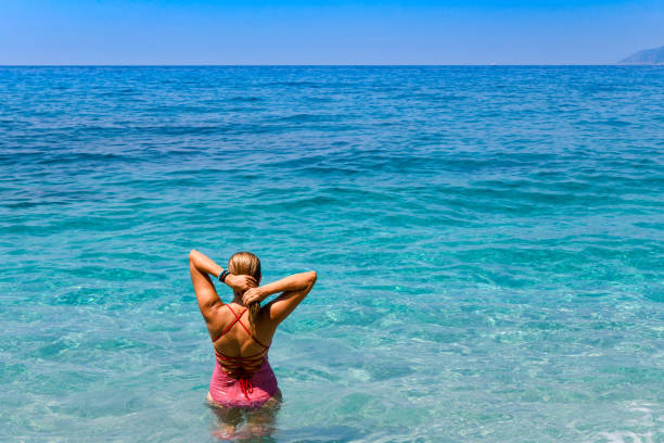 Woman floating in immaculate sea.