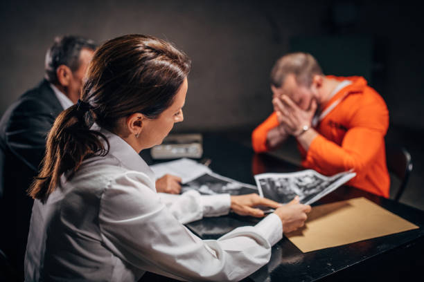 istock Detectives and prisoner in interrogation room 1166564519
