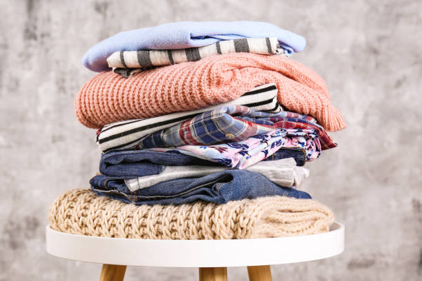 istock Bunch of different colorful clothing items folded in stack. 1166564678