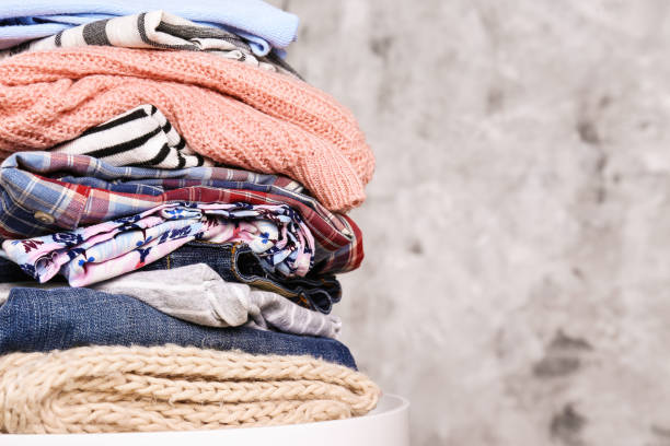 istock Bunch of different colorful clothing items folded in stack. 1166564681