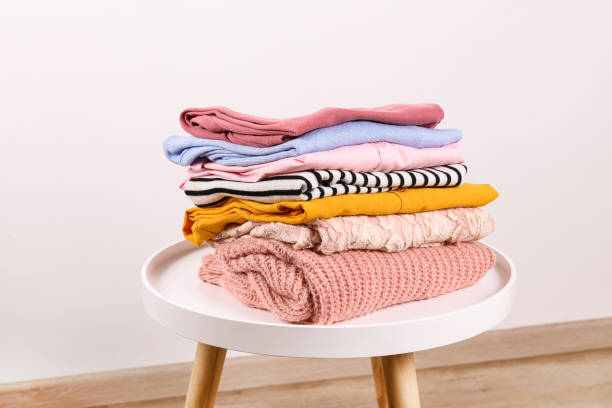 istock Bunch of different colorful clothing items folded in stack. 1166564689