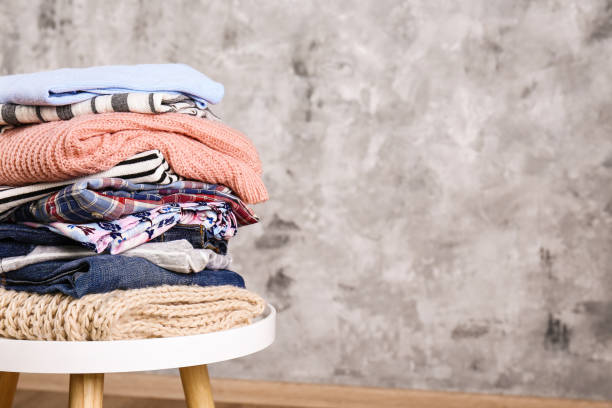 istock Bunch of different colorful clothing items folded in stack. 1166564690