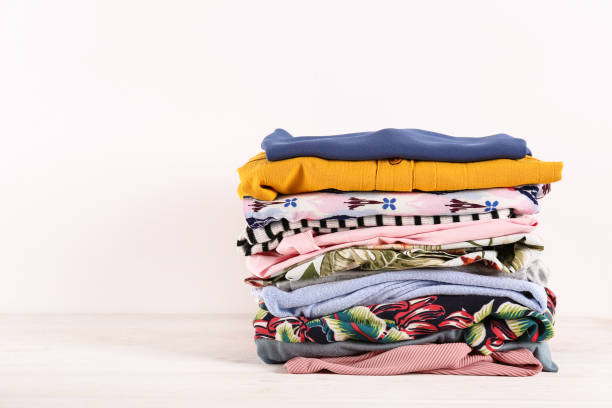 istock Bunch of different colorful clothing items folded in stack. 1166564784