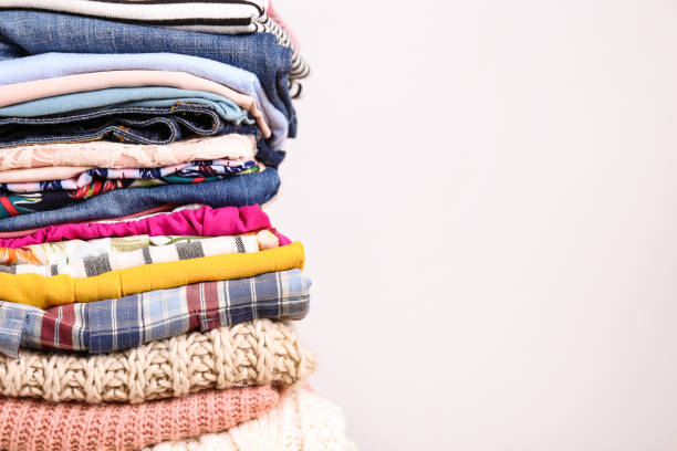 istock Bunch of different colorful clothing items folded in stack. 1166564785
