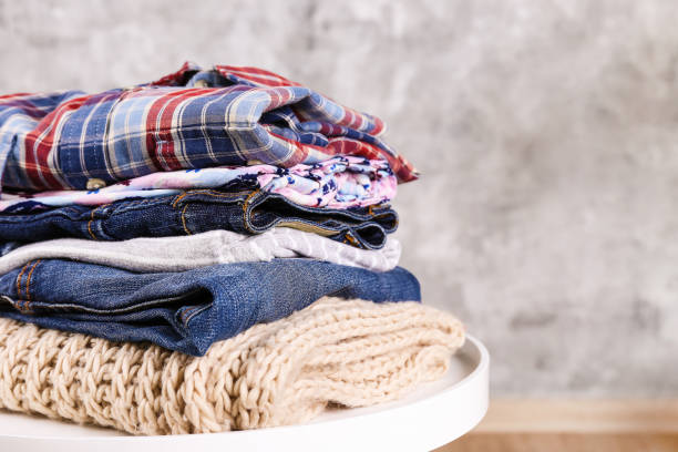 istock Bunch of different colorful clothing items folded in stack. 1166564827