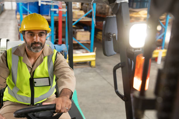 istock Male staff driving forklift in warehouse 1166565612