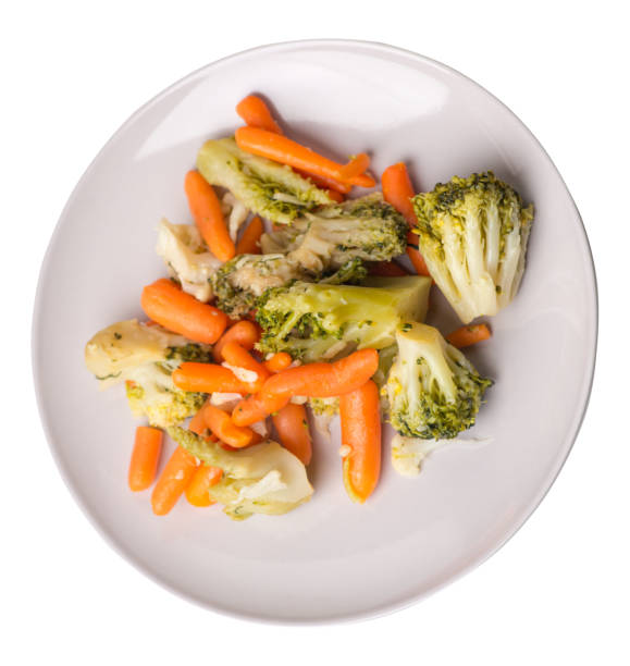 istock provencal vegetables on a plate.grilled vegetables on a plate isolated on white background.broccoli and carrots on a plate top view.healthy  food 1166565999