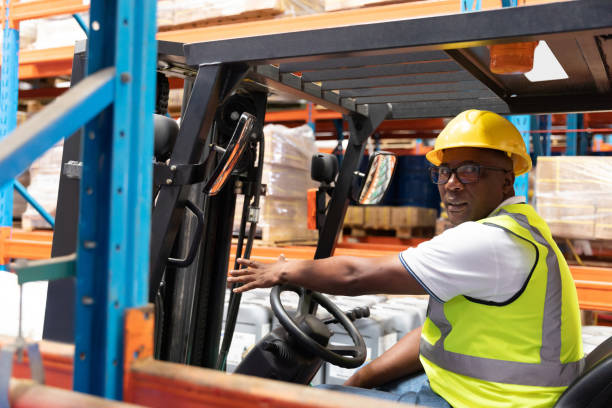istock Male staff driving forklift in warehouse 1166566058