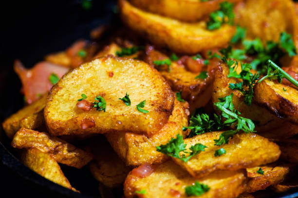 istock baked fried potatoes with garlic on wooden table background 1166566153