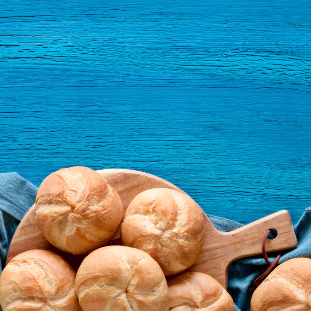 istock Crusty round bread rolls, known as Kaiser or Vienna rolls on linen towel 1166566434