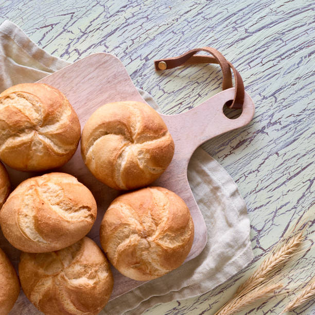 istock Crusty round bread rolls, known as Kaiser or Vienna rolls on linen towel 1166567090