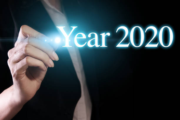 istock Hand holding a pen and writing year 2020. 1166567623