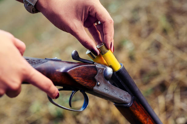 istock Close up of a female hunter reloading her rifle. 1166568795