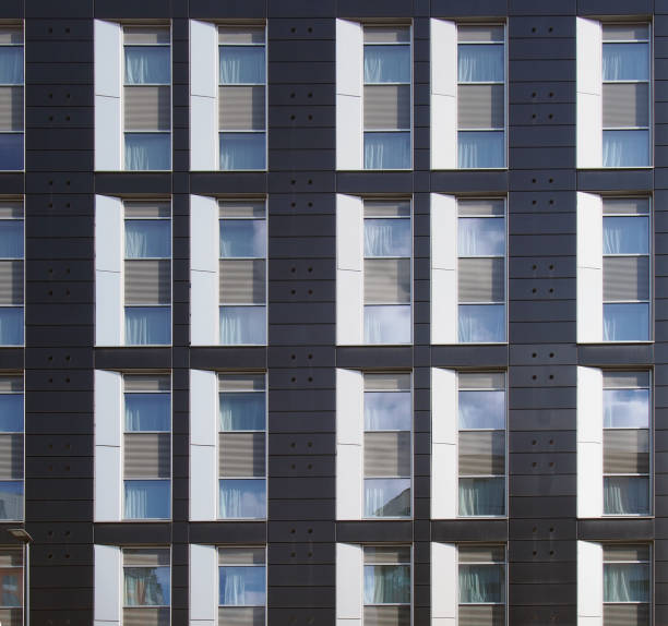 istock facade of a large black and white modern commercial building with repeating windows and geometric panels 1166569959