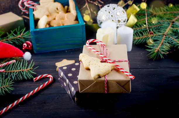 istock Christmas composition with gingerbread and gift on wooden table 1166570570