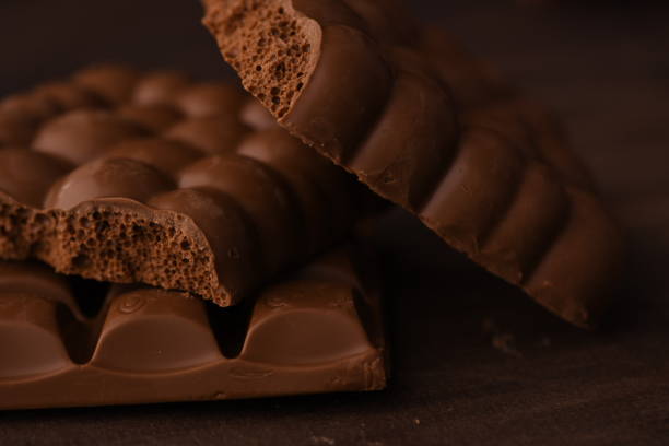 Crunchy Brown Chocolate pieces on wooden table. This is a closeup shot