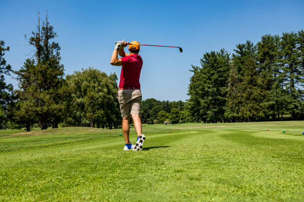 istock Close up Golfer is driving golf ball to green course 1166570754