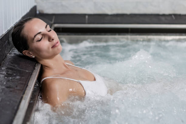 istock Young female relaxing in hot tub 1166572367
