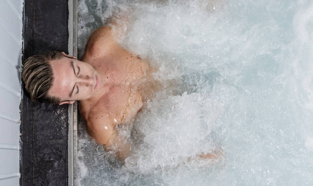 istock Handsome male enjoying hot whirlpool bath 1166572368