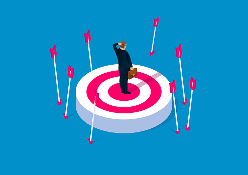 Off-target, failure concept, desperate businessman standing on target without hit