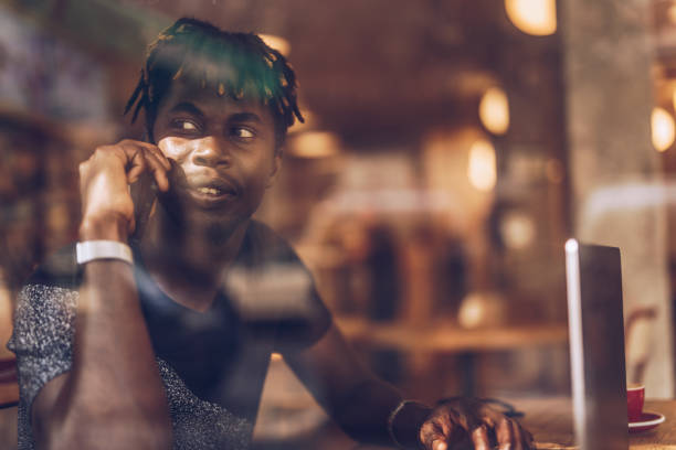 istock Man sitting in coffee shop and multi-tasking 1166573062