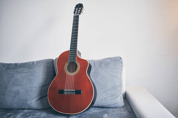 istock Acoustic guitar on a living room couch / sofa. 1166573591