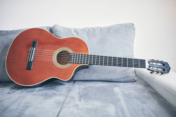 istock Acoustic guitar on a living room couch / sofa. 1166573632