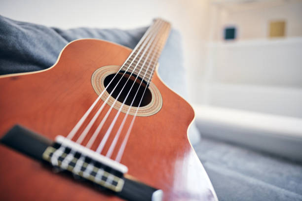 istock Acoustic guitar on a living room couch / sofa. 1166573673