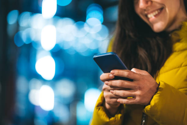 istock Woman using phone on street 1166573686