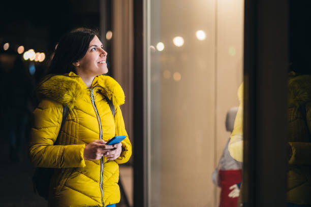 istock Woman in front of store window 1166573701
