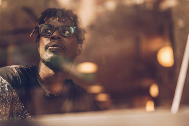 istock Young man sitting in coffee shop and using laptop 1166573817