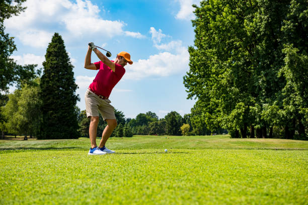 istock Close up Golfer is driving golf ball to green course 1166574007
