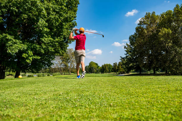 istock Close up Golfer is driving golf ball to green course 1166576211
