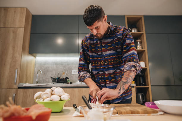 istock Focused modern looking hipster cooking at home 1166576508