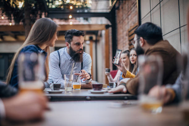istock Friends sitting in sidewalk cafe 1166577722
