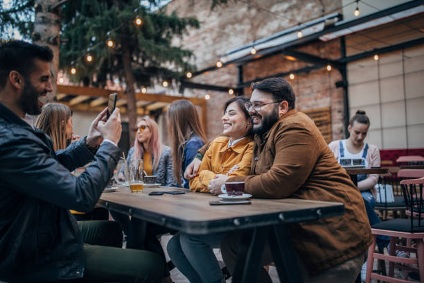 istock Friends sitting outdoors in cafe 1166578110