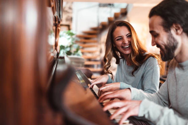 istock couple playing the piano together at home 1166579100
