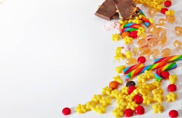 istock Sweets scattered on the table: chocolate, caramel, Breakfast cereals on a white background 1166579169