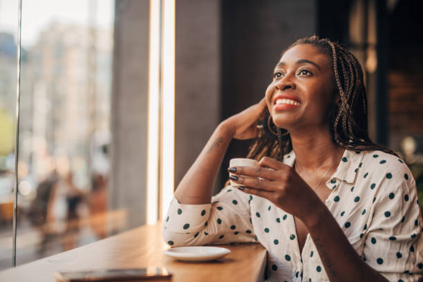 istock Young woman drinking coffee at the cafe 1166579233