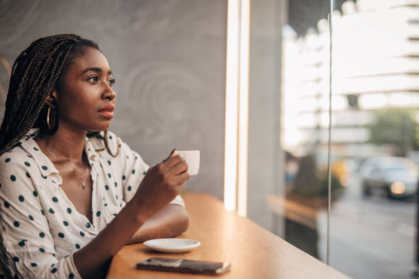 istock Young woman drinking coffee at the cafe 1166579372