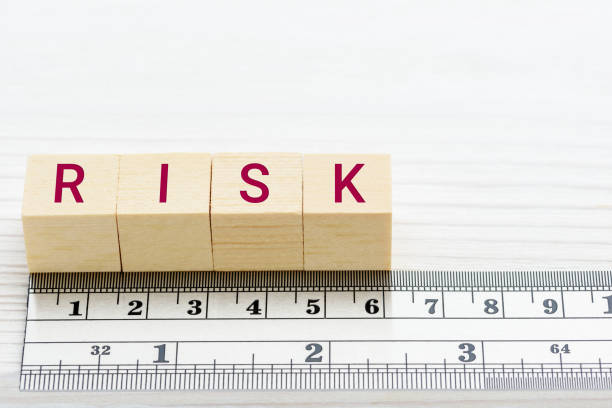Risk assessment / risk scale analysis and management concept : Words RISK on wood blocks and a ruler, depict uncertainty financial risk or credit profile an investor involved in a trading stock market Risk assessment / risk scale analysis and management concept : Words RISK on wood blocks and a ruler, depict uncertainty financial risk or credit profile an investor involved in a trading stock market ponzi scheme stock pictures, royalty-free photos & images