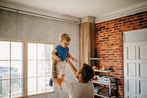 istock Father and son cuddling in bed 1166579737