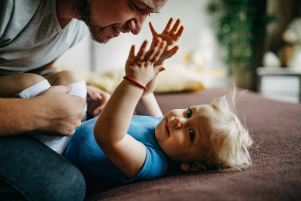 istock Father and son cuddling in bed 1166579830