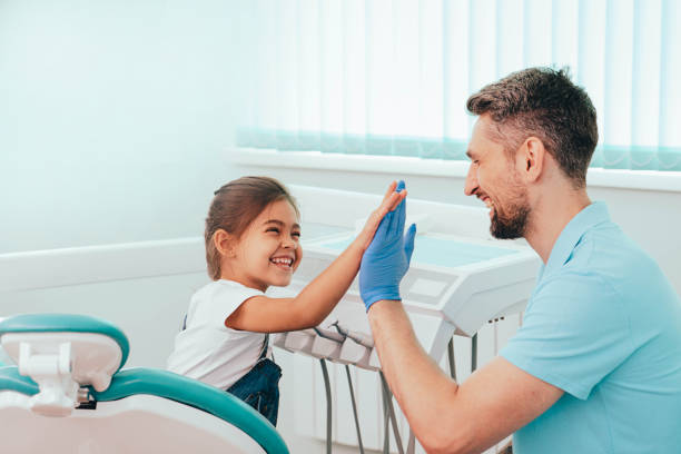 Child visit dentist. Laughing Little girl have five to dentist at dental clinic Child visit dentist. Laughing Little girl have five to dentist at dental clinic pediatric dentistry stock pictures, royalty-free photos & images