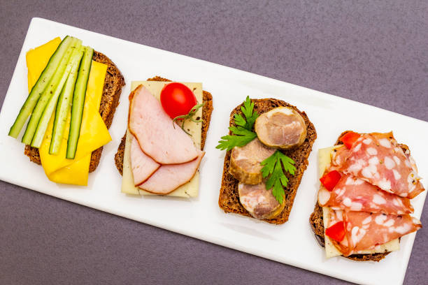 istock Assorted sandwiches with different fillings, meats, cheese and vegetables 1166580809