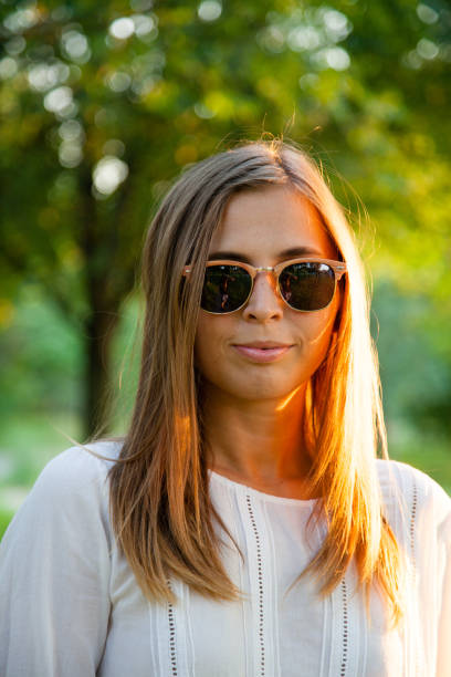 istock Young woman with sunglasses on a sunny day 1166581939
