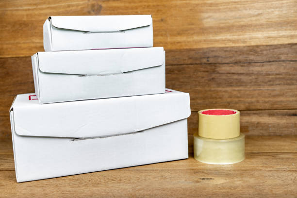 istock Cardboard boxes stacked with copy space on wooden table.  Object for small business concept. 1166583187