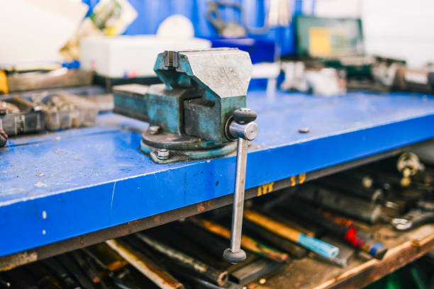 istock Vise blue in the workshop. Joiner tools for fixing parts for various types of processing. Metal clamps. 1166583250